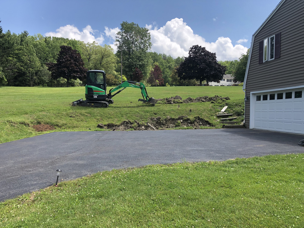 Excavator digging for retaining wall